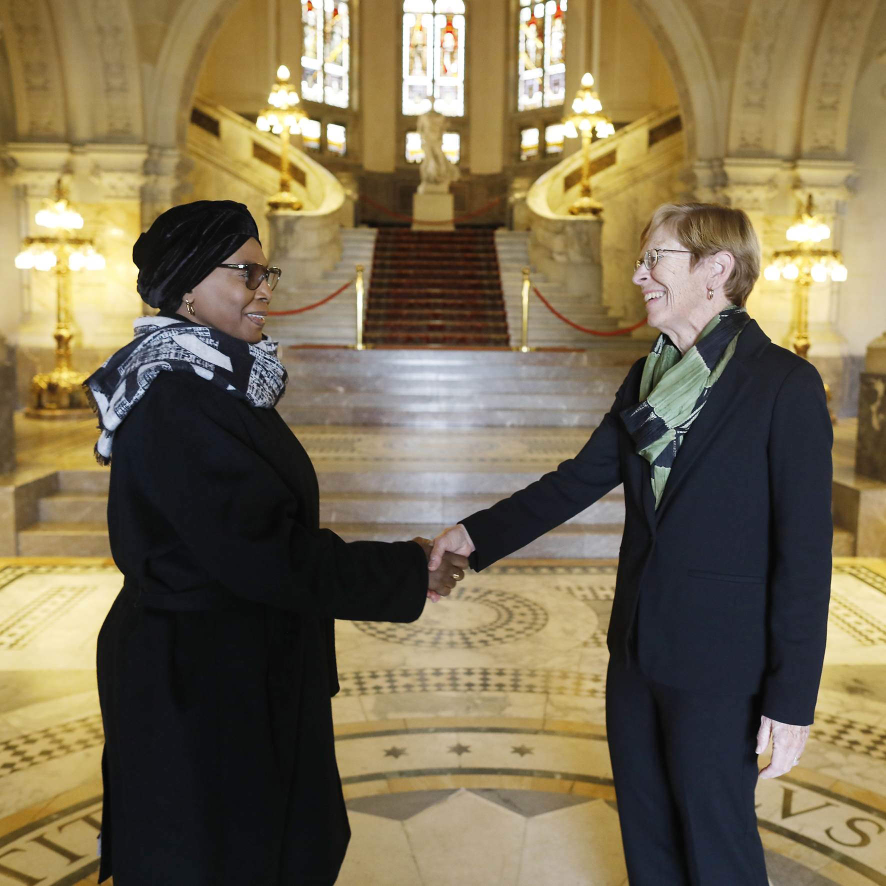 H.E. Judge Joan E. Donoghue, President of the International Court of Justice, greets H.E. Judge lmani D. Aboud, President of the African Court on Human and  Peoples’ Rights, and her delegation, in the entrance hall of the Peace Palace, seat of the Court